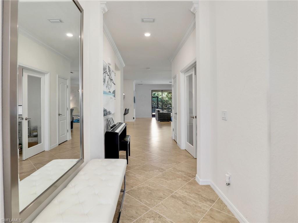 4212 Raffia Palm Circle Naples, FL 34119 - Photo 6 of 49 a view of a hallway with a furniture