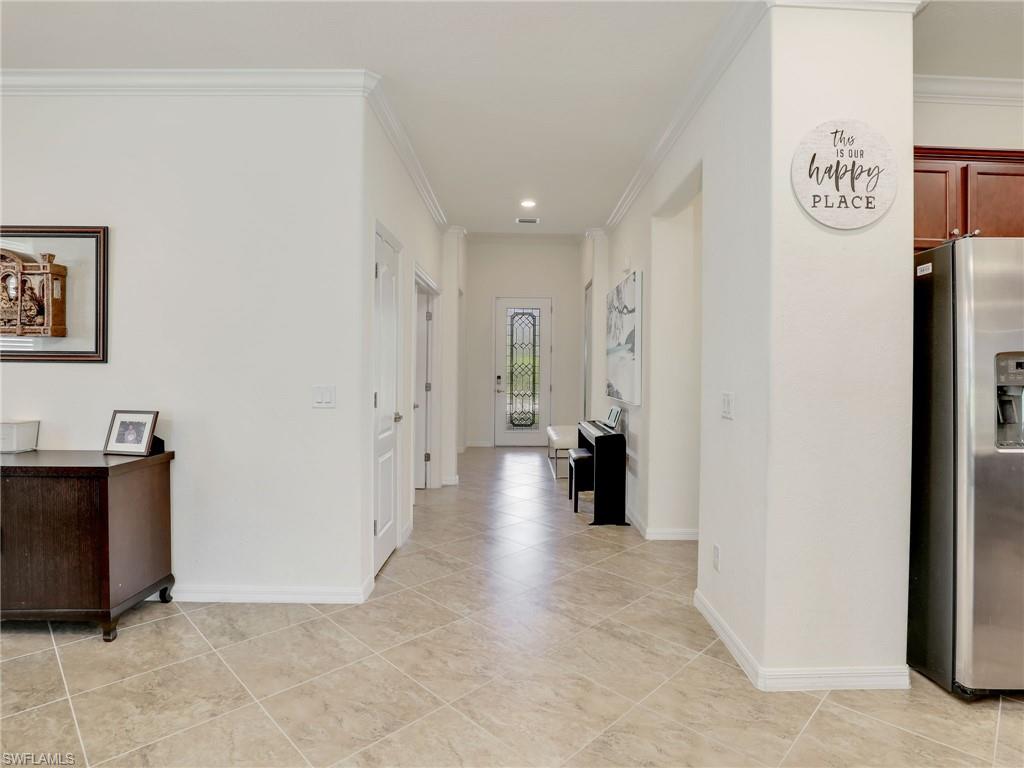 4212 Raffia Palm Circle Naples, FL 34119 - Photo 7 of 49 a view of a hallway with painted walls