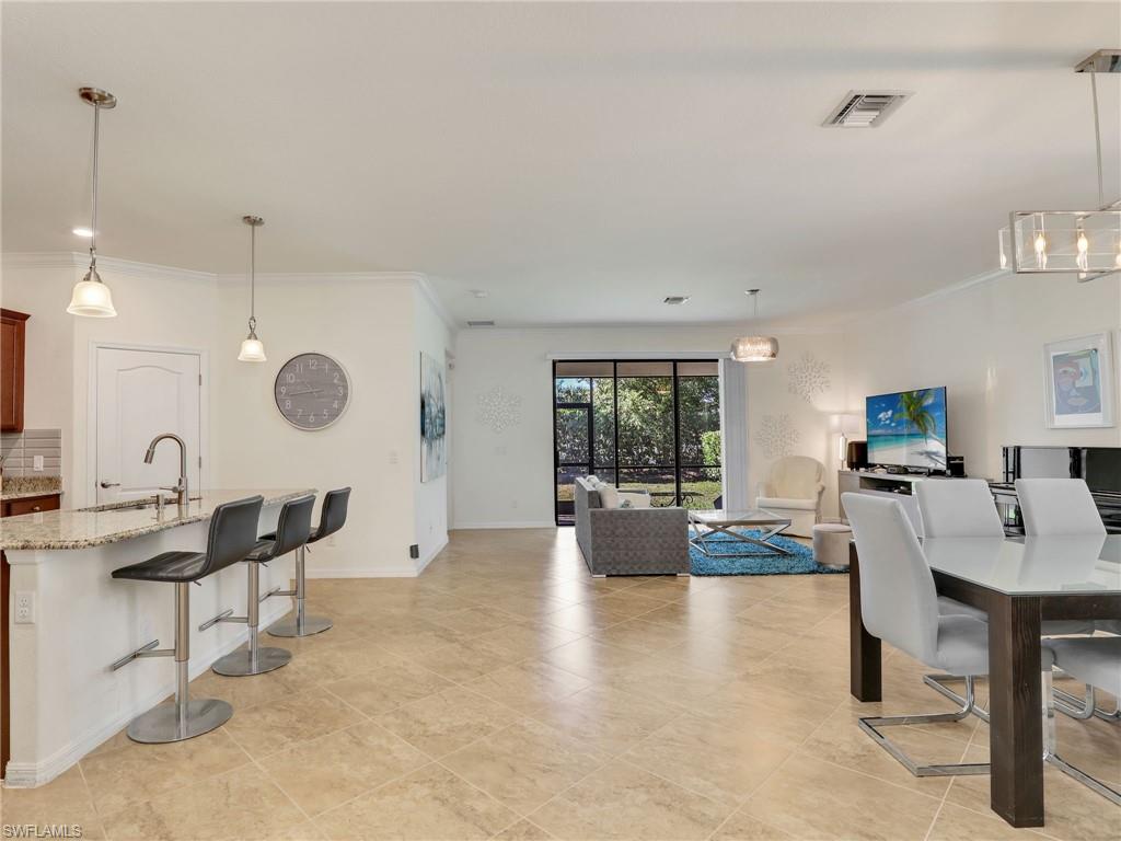 4212 Raffia Palm Circle Naples, FL 34119 - Photo 8 of 49 a view of a living room and dining room