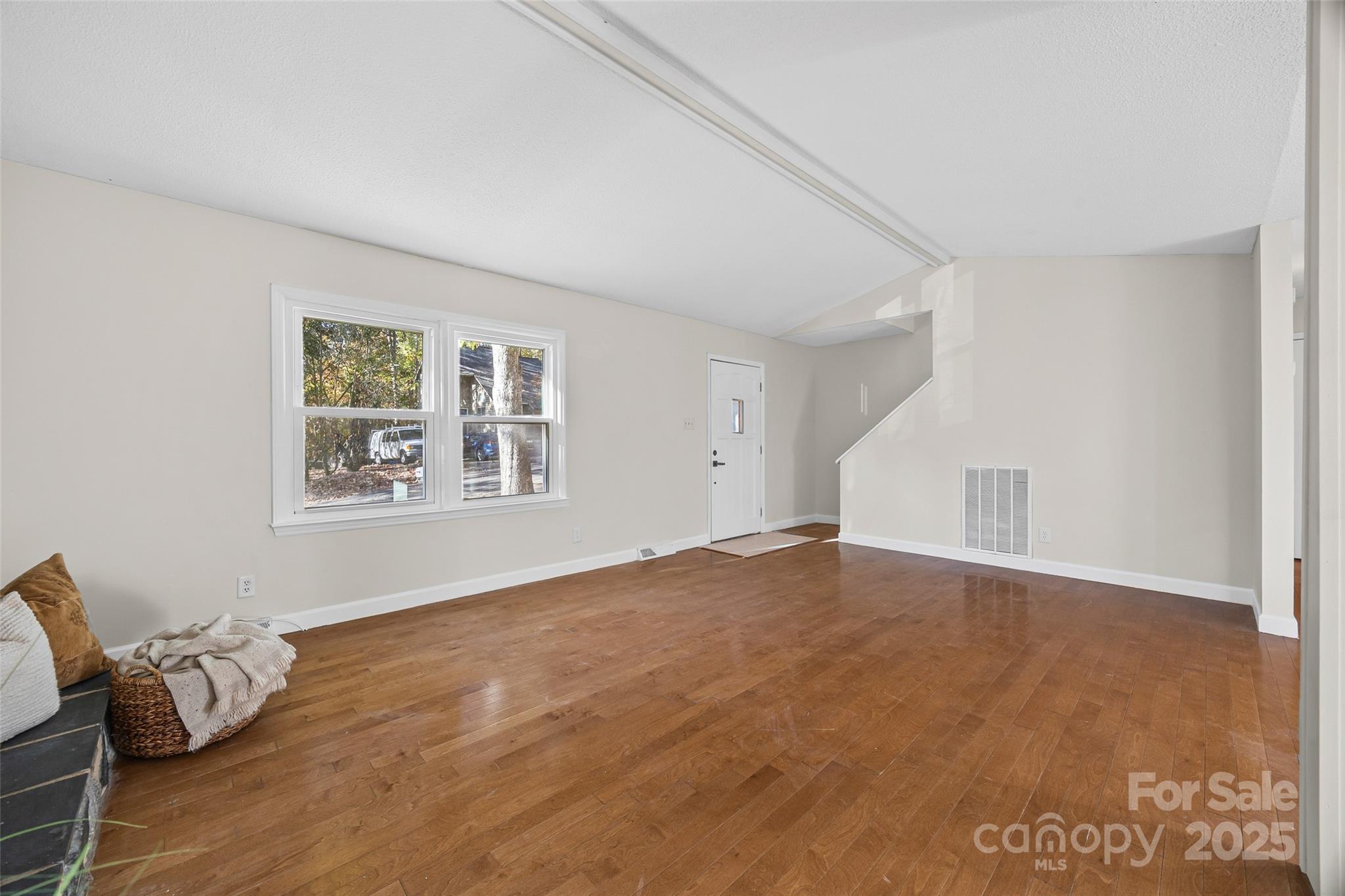 2137 Manawa Lane Tega Cay, SC 29708 - Photo 13 of 48 a view of an empty room with window and wooden floor