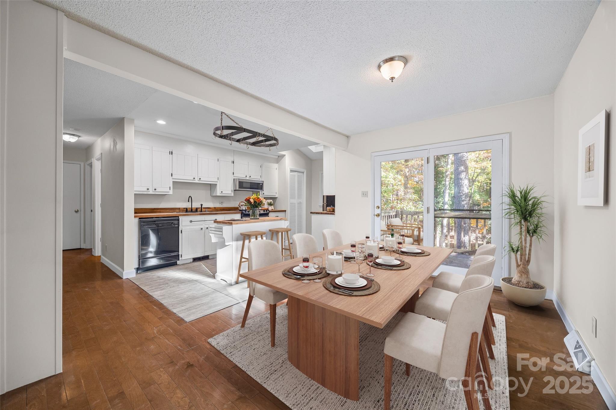 2137 Manawa Lane Tega Cay, SC 29708 - Photo 14 of 48 a view of a dining room and livingroom with furniture wooden floor and a large window