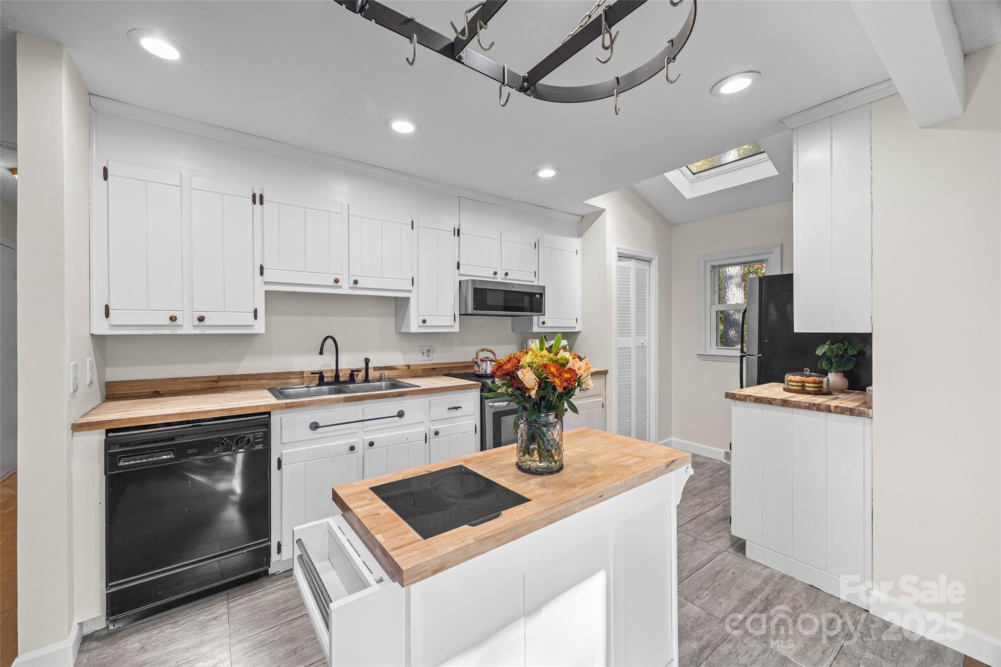 2137 Manawa Lane Tega Cay, SC 29708 - Photo 17 of 48 a kitchen that has a lot of cabinets in it and wooden floors