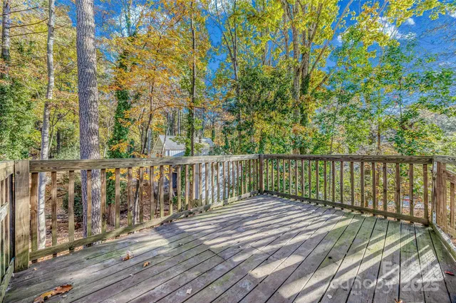 a balcony with wooden floor and fence