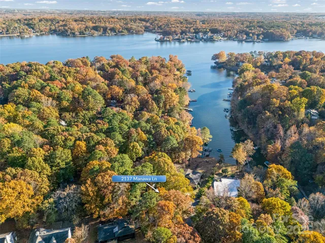 an aerial view of lake and residential houses with outdoor space