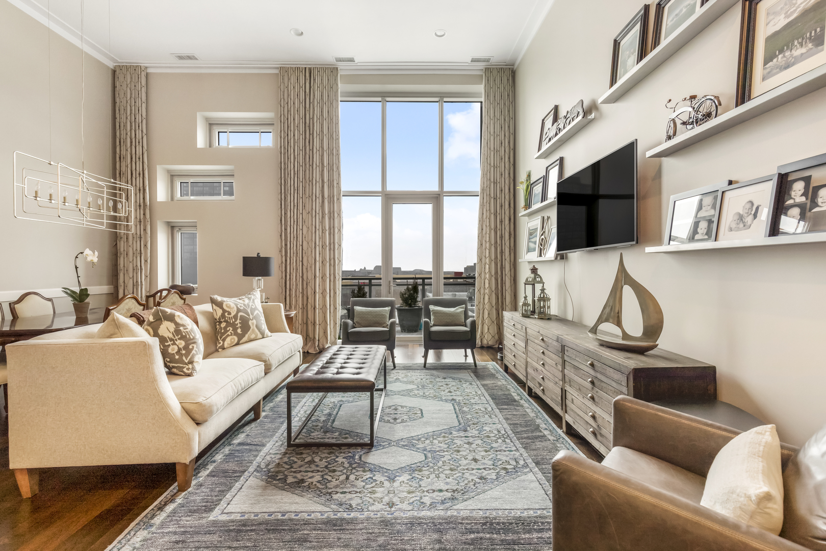 1120 West Adams Street, Unit PHW Chicago, IL 60607 - Photo 4 of 23 a living room with furniture a flat screen tv and a fireplace