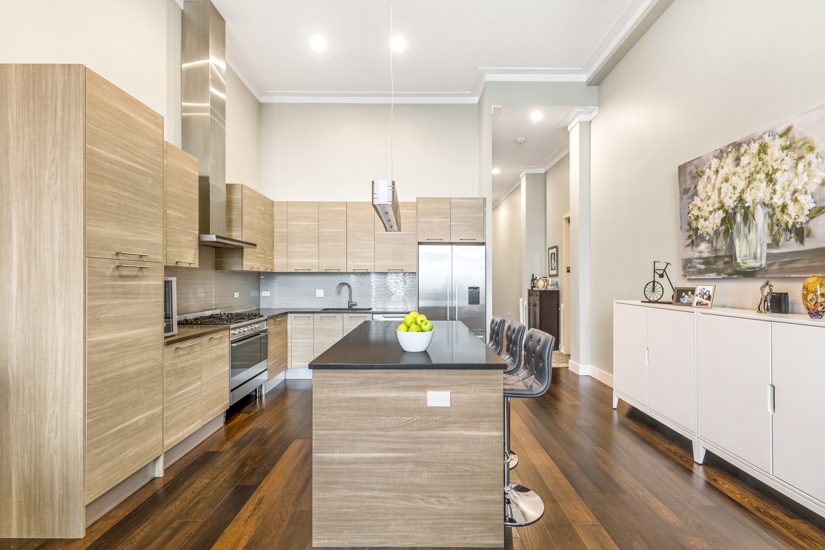 1120 West Adams Street, Unit PHW Chicago, IL 60607 - Photo 6 of 23 a kitchen with stainless steel appliances kitchen island granite countertop a sink and cabinets