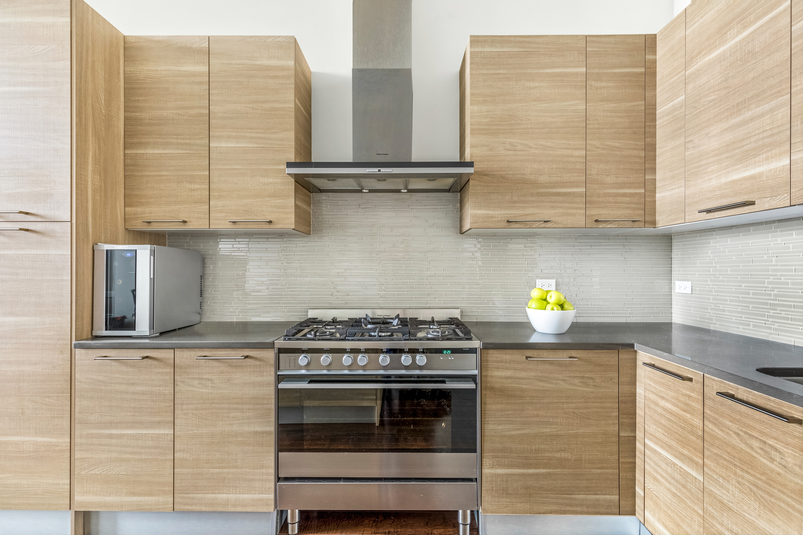 1120 West Adams Street, Unit PHW Chicago, IL 60607 - Photo 7 of 23 a kitchen with stainless steel appliances granite countertop a stove and a sink