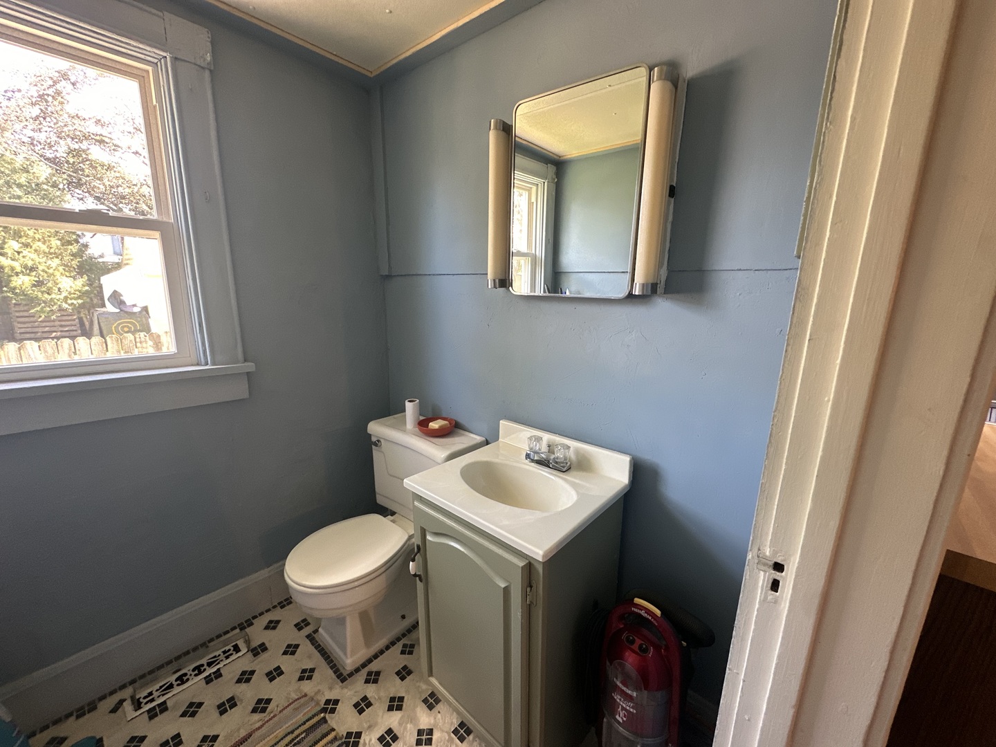 308 South Genesee Street Morrison, IL 61270 - Photo 11 of 24 a bathroom with a toilet sink vanity and mirror