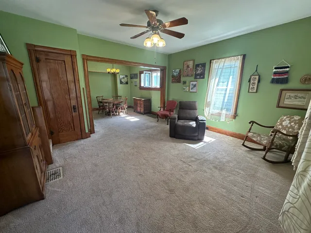 a living room with furniture and a chandelier