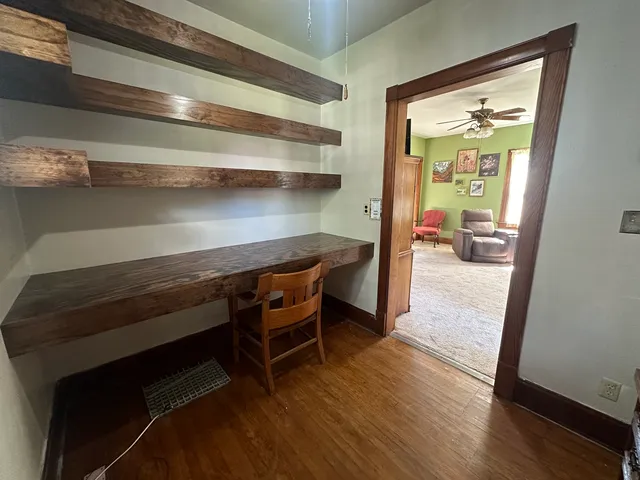 a view of room with wooden floor and furniture