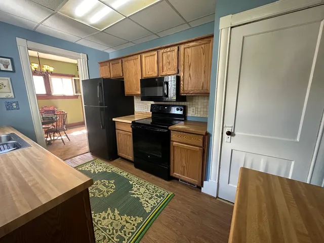 a kitchen with stainless steel appliances granite countertop a refrigerator and a stove
