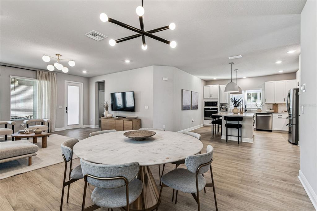 28748 Rambutan Drive Wesley Chapel, FL 33543 - Photo 16 of 37 a view of a dining room with furniture and wooden floor