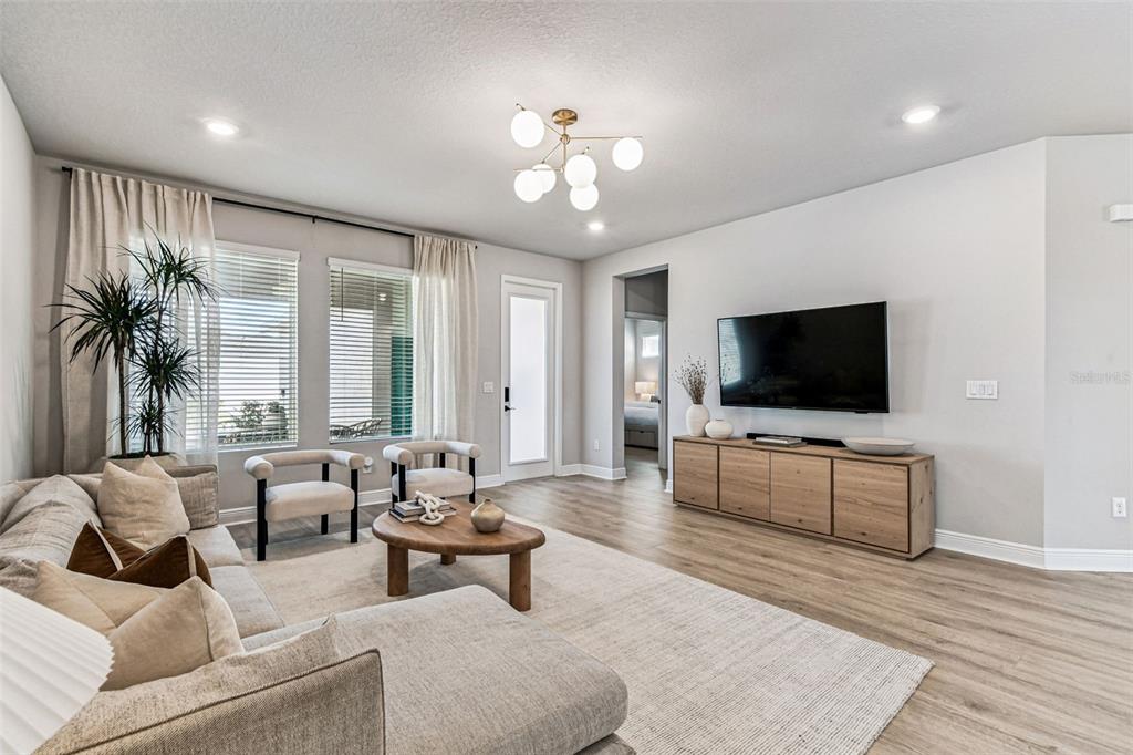 28748 Rambutan Drive Wesley Chapel, FL 33543 - Photo 19 of 37 a living room with furniture and a flat screen tv