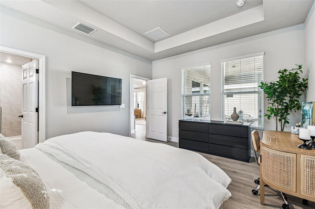 28748 Rambutan Drive Wesley Chapel, FL 33543 - Photo 21 of 37 a bedroom with a bed window and mirror