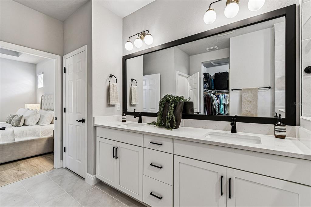 28748 Rambutan Drive Wesley Chapel, FL 33543 - Photo 23 of 37 a bathroom with double vanity sinks and a mirror