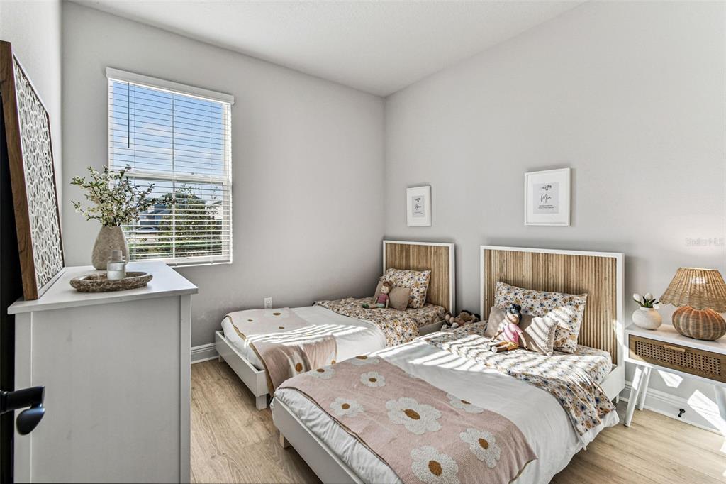 28748 Rambutan Drive Wesley Chapel, FL 33543 - Photo 7 of 37 a bedroom with two beds and painted walls