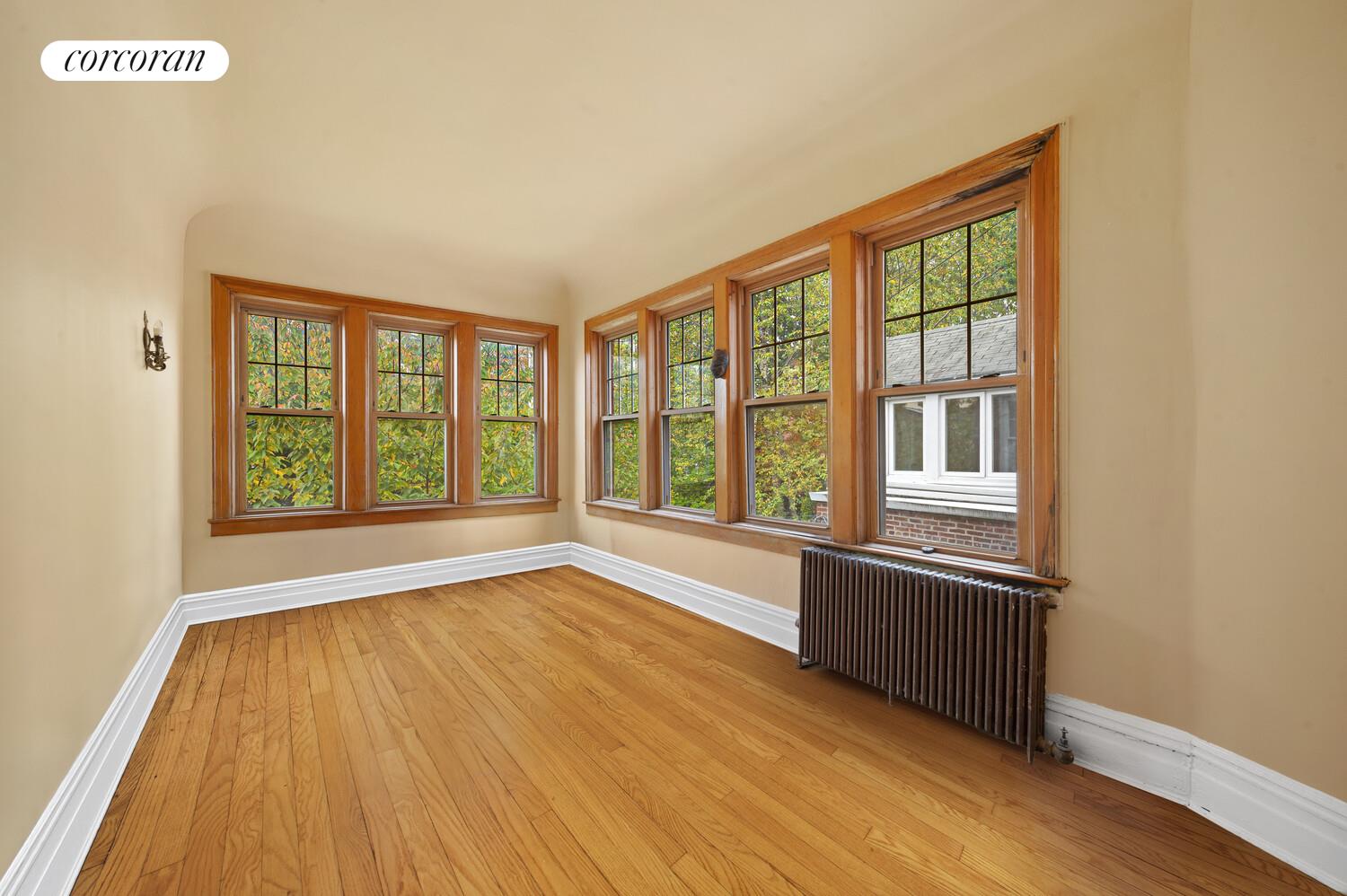 78 Midwood Street Brooklyn, NY 11225 - Photo 4 of 5 wooden floor in an empty room with a window