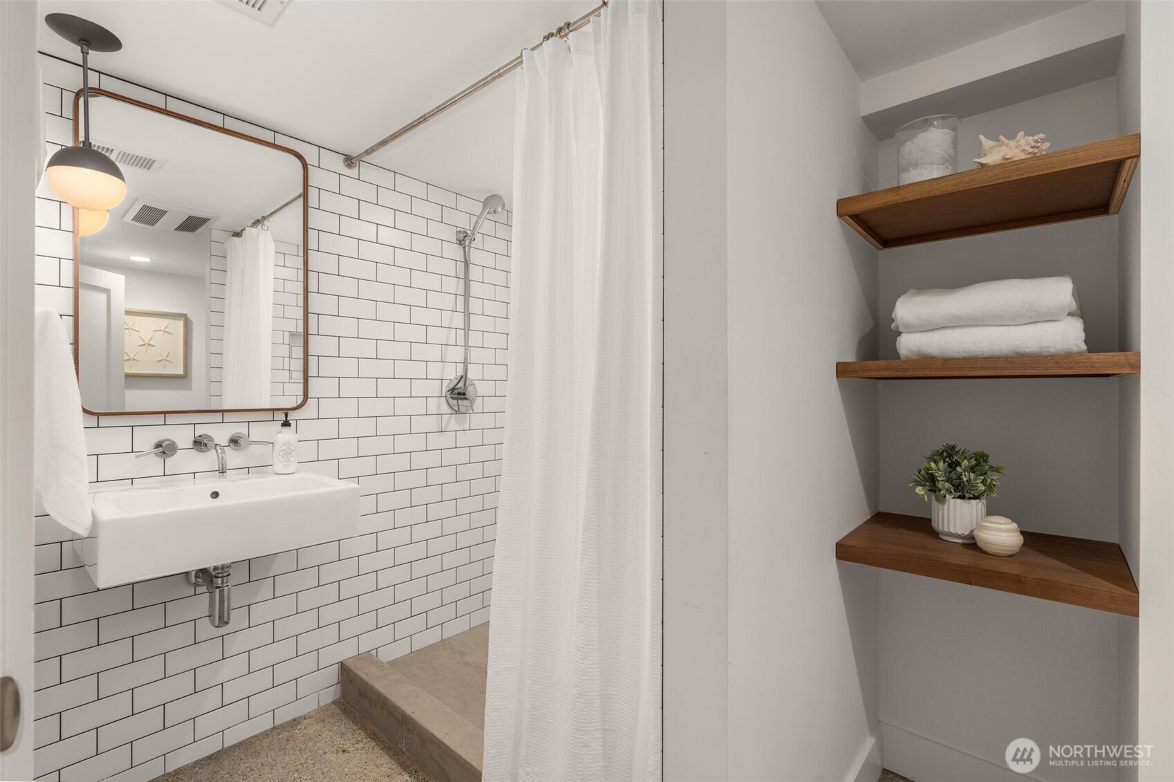 170 Lynn Street Seattle, WA 98109 - Photo 28 of 40 a bathroom with a toilet sink and mirror