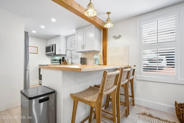 a kitchen with a sink cabinets and window