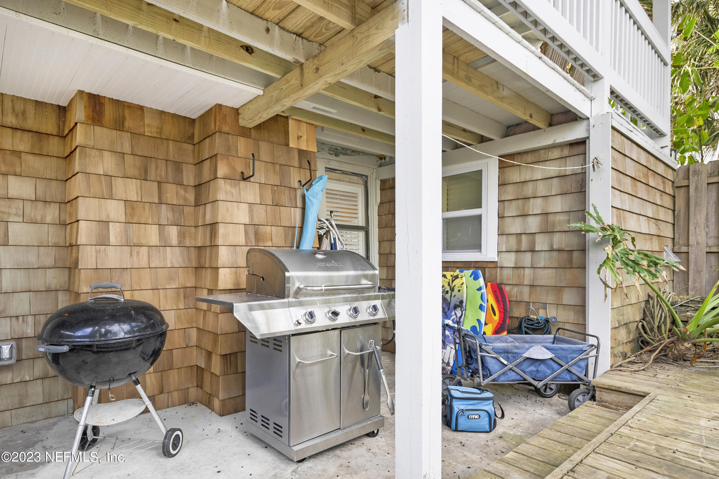 23 26th Avenue South, Unit LOWR Jacksonville Beach, FL 32250 - Photo 19 of 23 a view of a chairs and table in a patio
