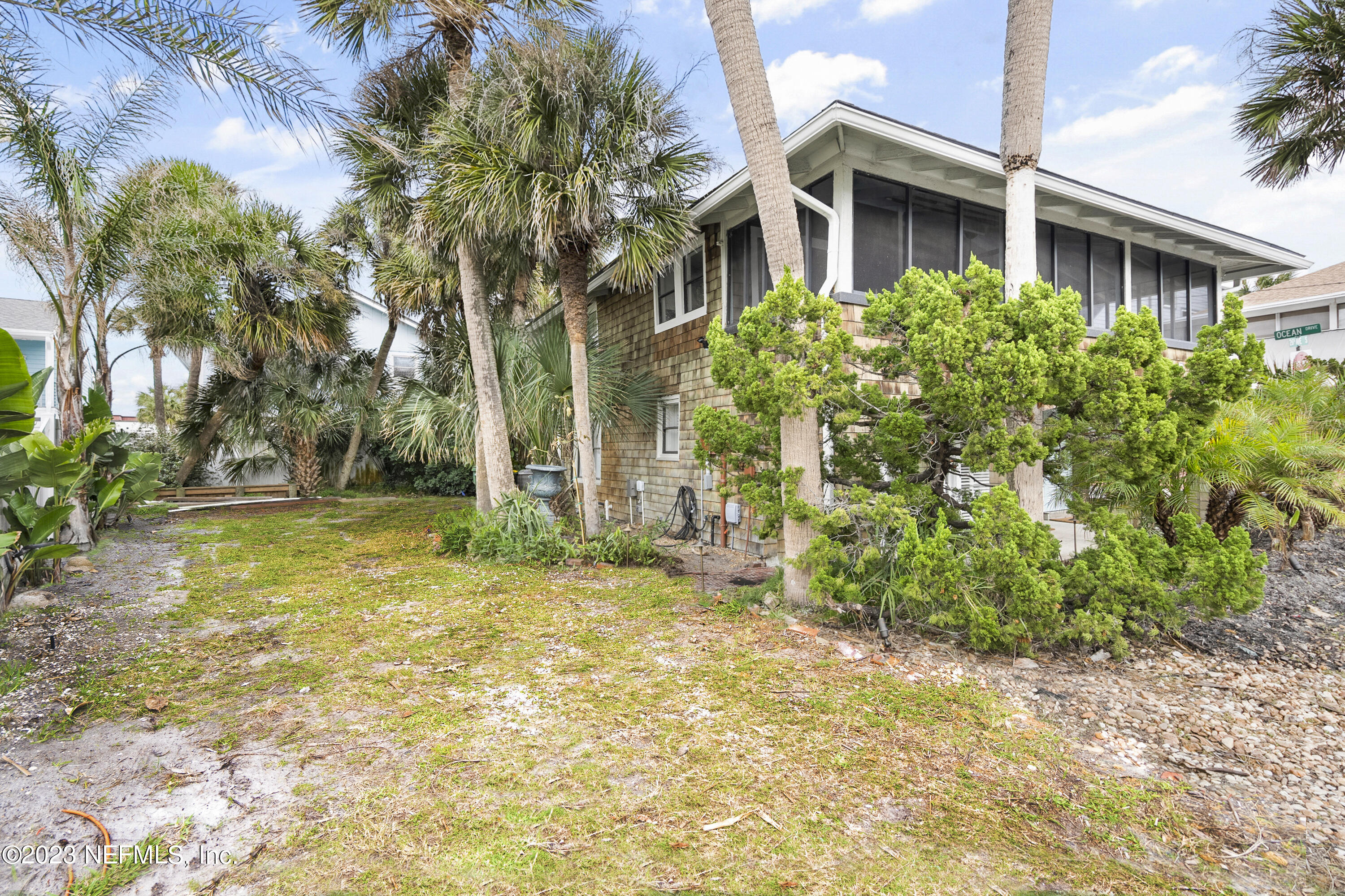 23 26th Avenue South, Unit LOWR Jacksonville Beach, FL 32250 - Photo 22 of 23 a yellow house with trees in front of it