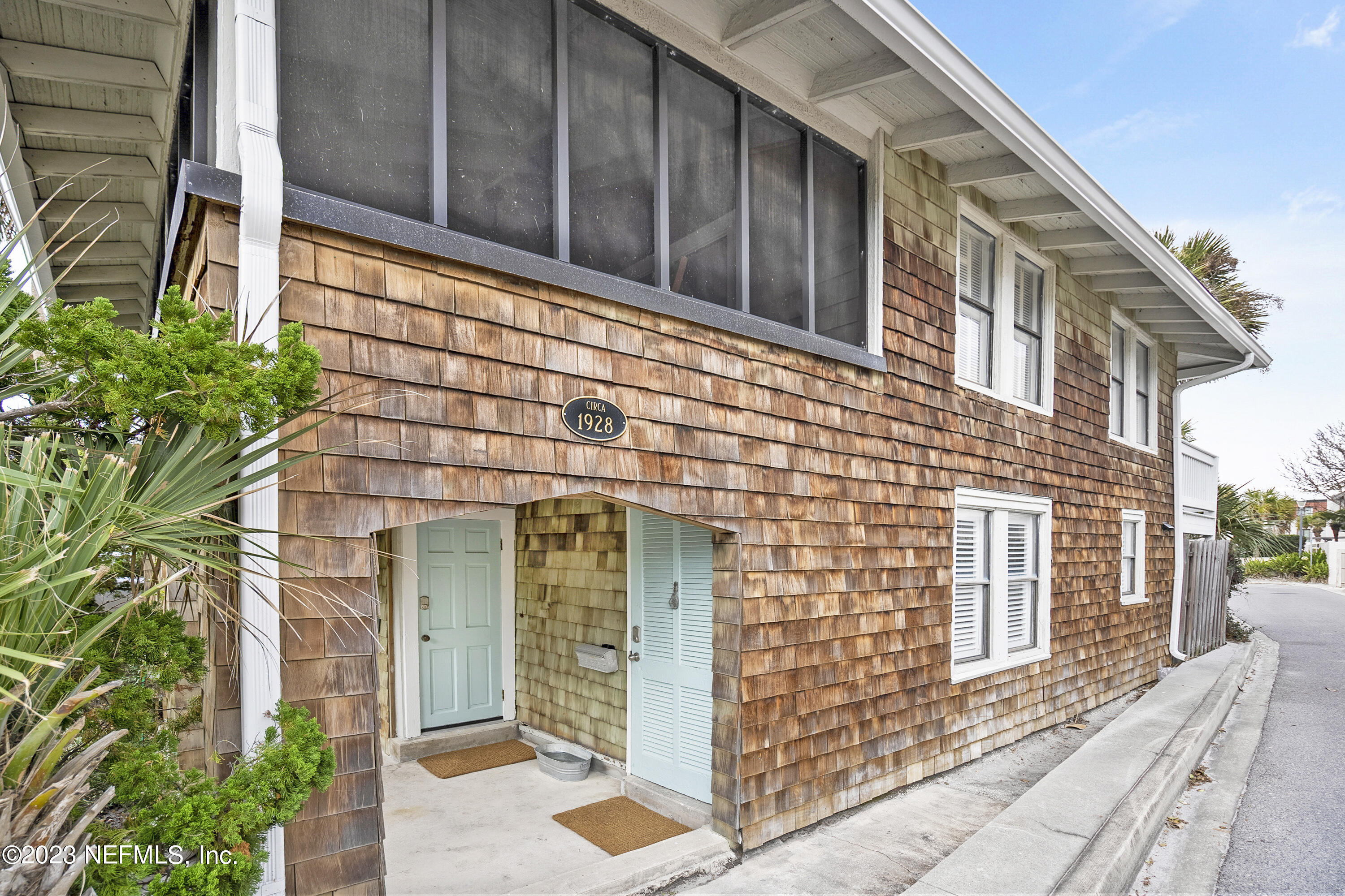 23 26th Avenue South, Unit LOWR Jacksonville Beach, FL 32250 - Photo 6 of 23 a front view of a house with a garden