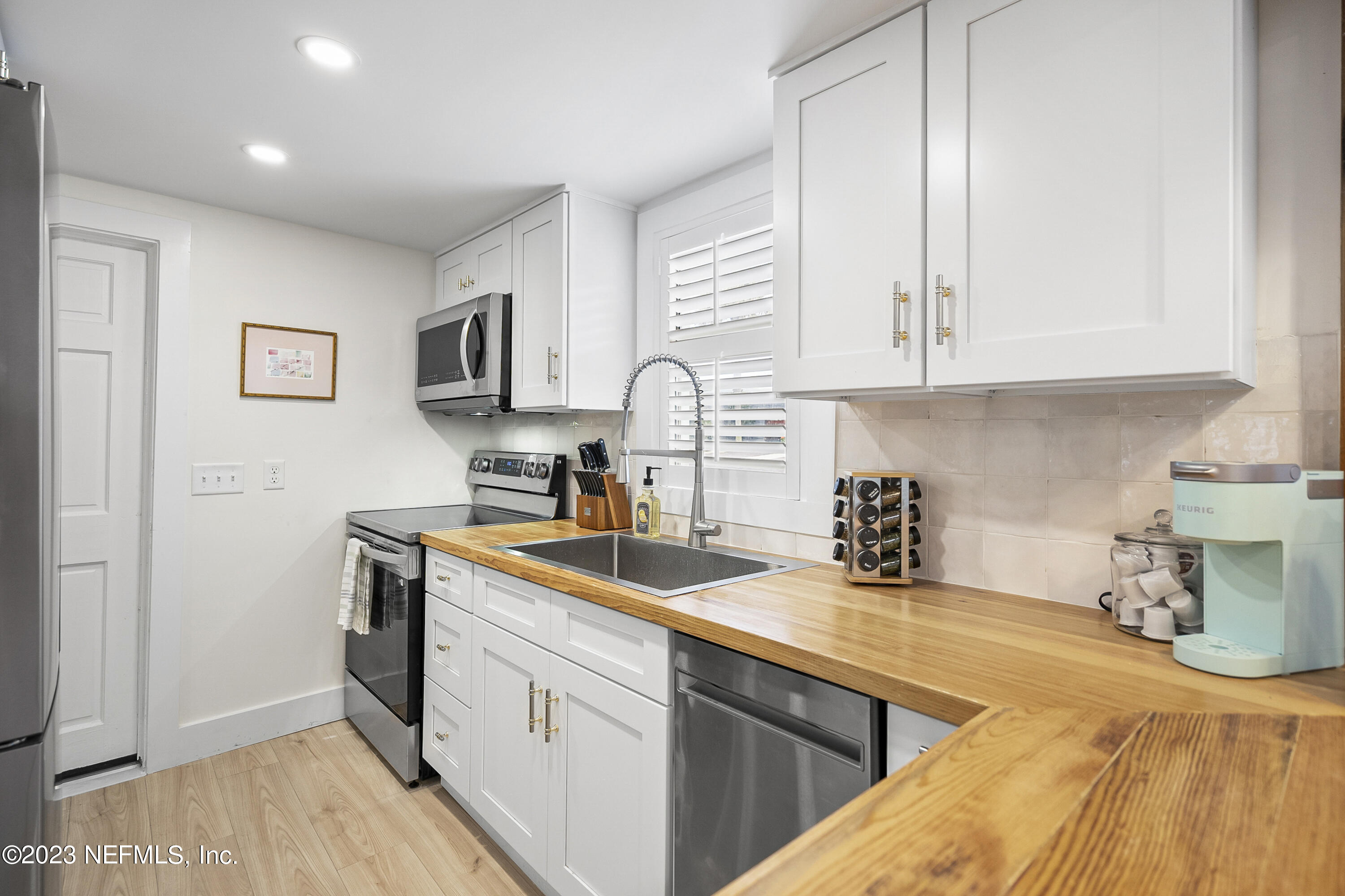 23 26th Avenue South, Unit LOWR Jacksonville Beach, FL 32250 - Photo 7 of 23 a kitchen with a sink and cabinets
