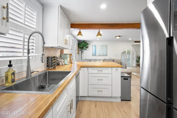 a kitchen with a sink stove and cabinets