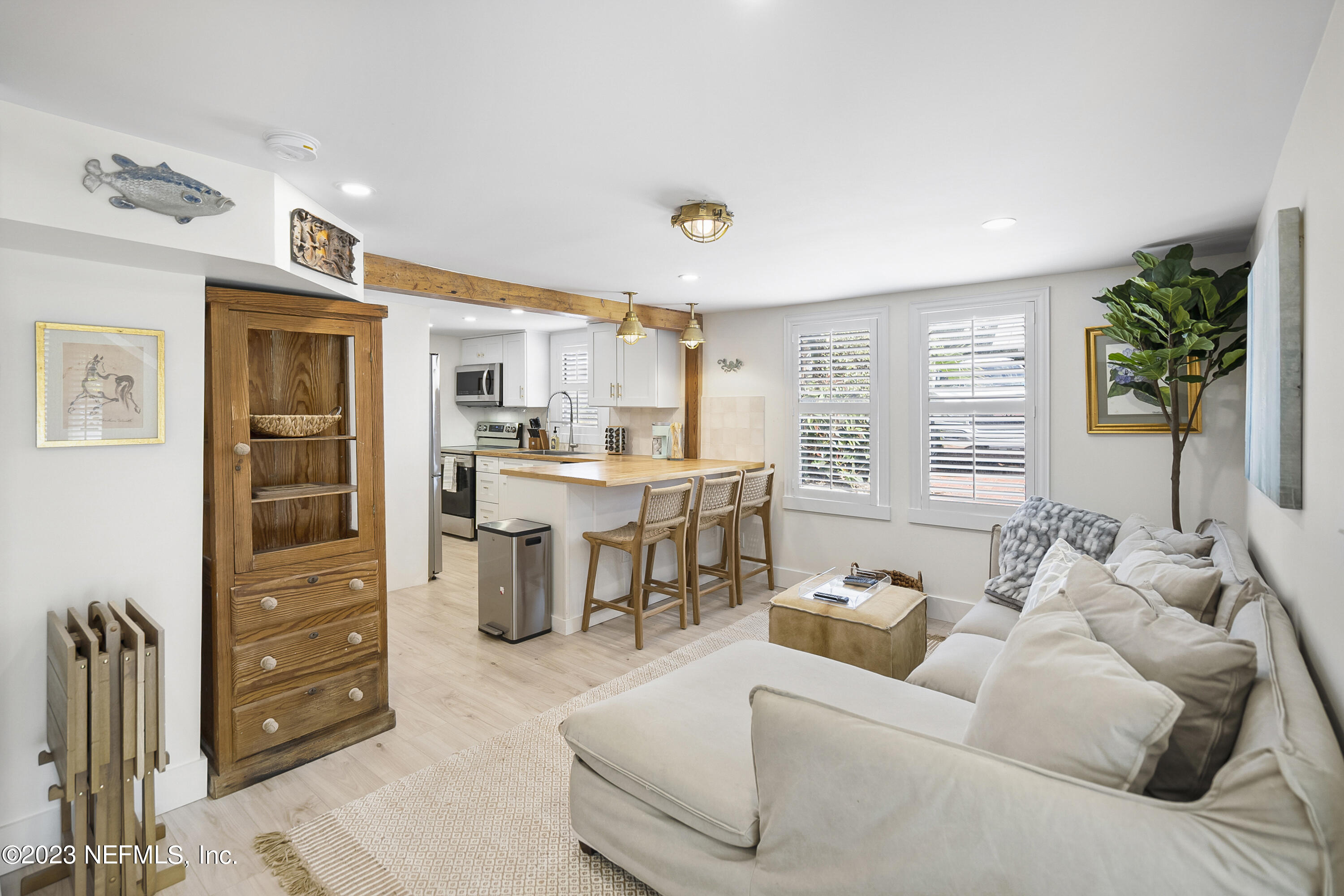 23 26th Avenue South, Unit LOWR Jacksonville Beach, FL 32250 - Photo 10 of 23 a living room with furniture and a window