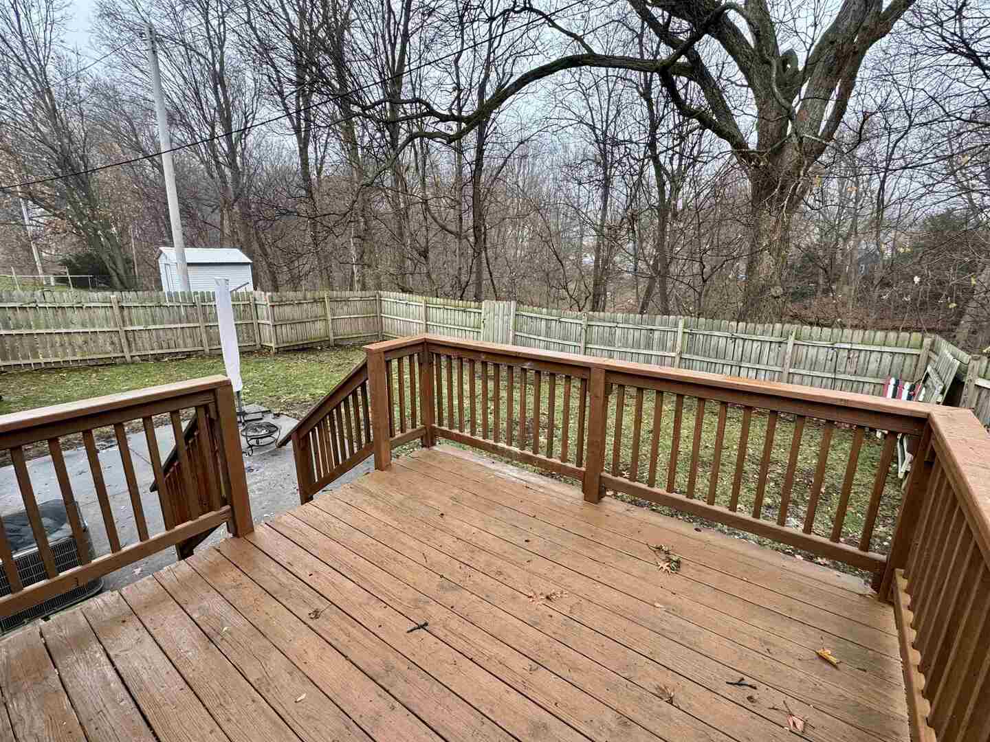 1819 47th St Court Moline, IL 61265 - Photo 2 of 2 a balcony with wooden floor and trees in the back