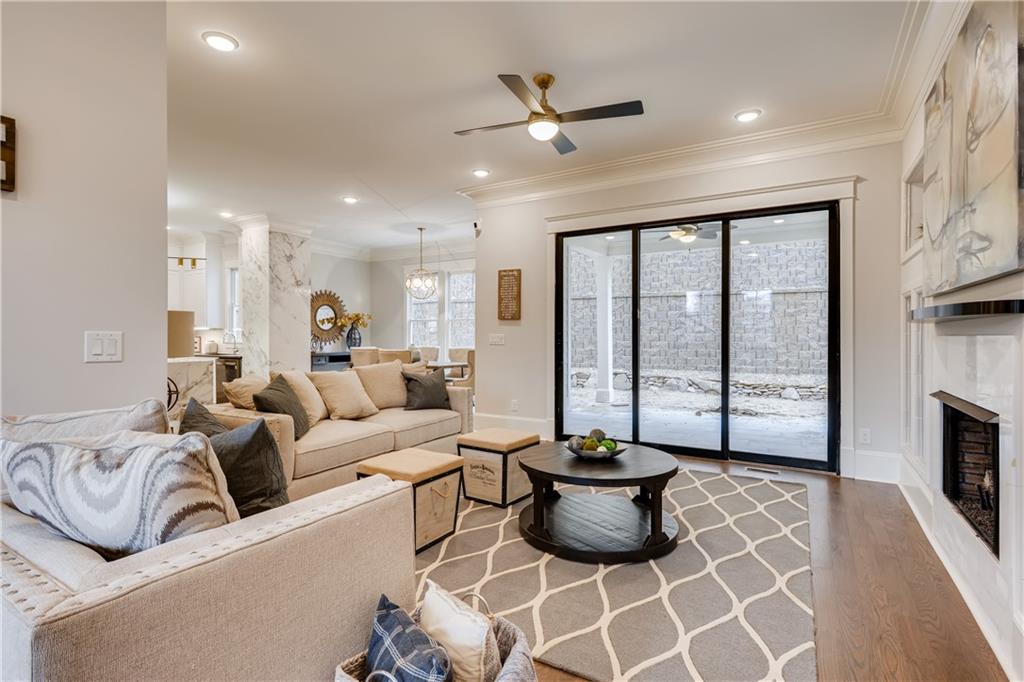 a living room with furniture a flat screen tv and a large window