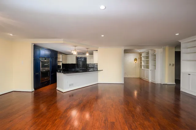 a view of kitchen with refrigerator microwave and stove