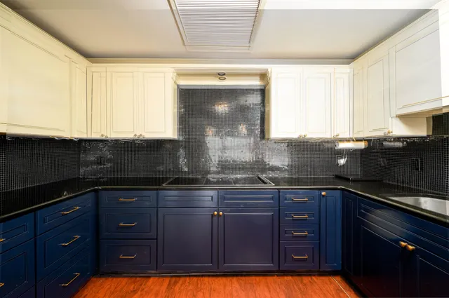 a kitchen with granite countertop wooden cabinets and a sink