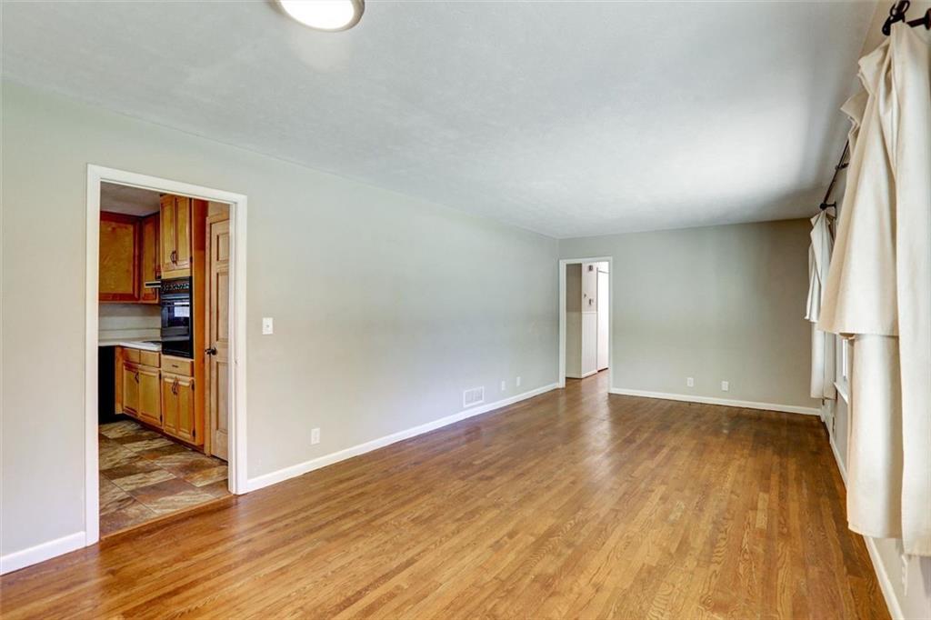 1266 Hickory Drive Southwest Lilburn, GA 30047 - Photo 16 of 49 an empty room with wooden floor and closet