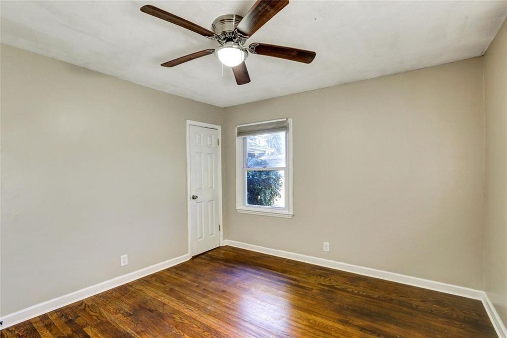 1266 Hickory Drive Southwest Lilburn, GA 30047 - Photo 27 of 49 a view of an empty room with wooden floor and a window