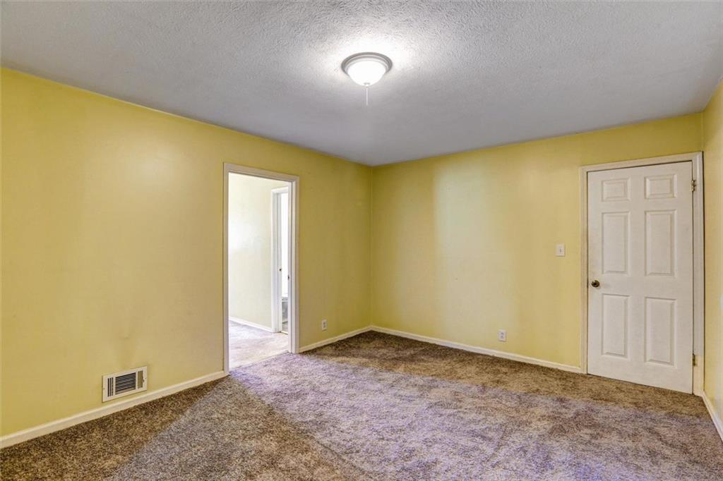 1266 Hickory Drive Southwest Lilburn, GA 30047 - Photo 31 of 49 an empty room with a window