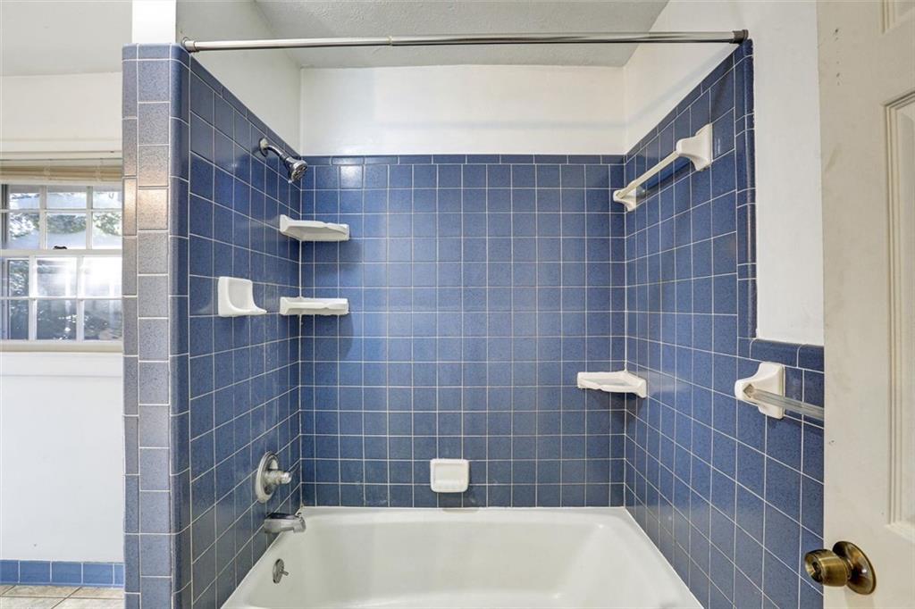 1266 Hickory Drive Southwest Lilburn, GA 30047 - Photo 32 of 49 a bathroom with a bathtub