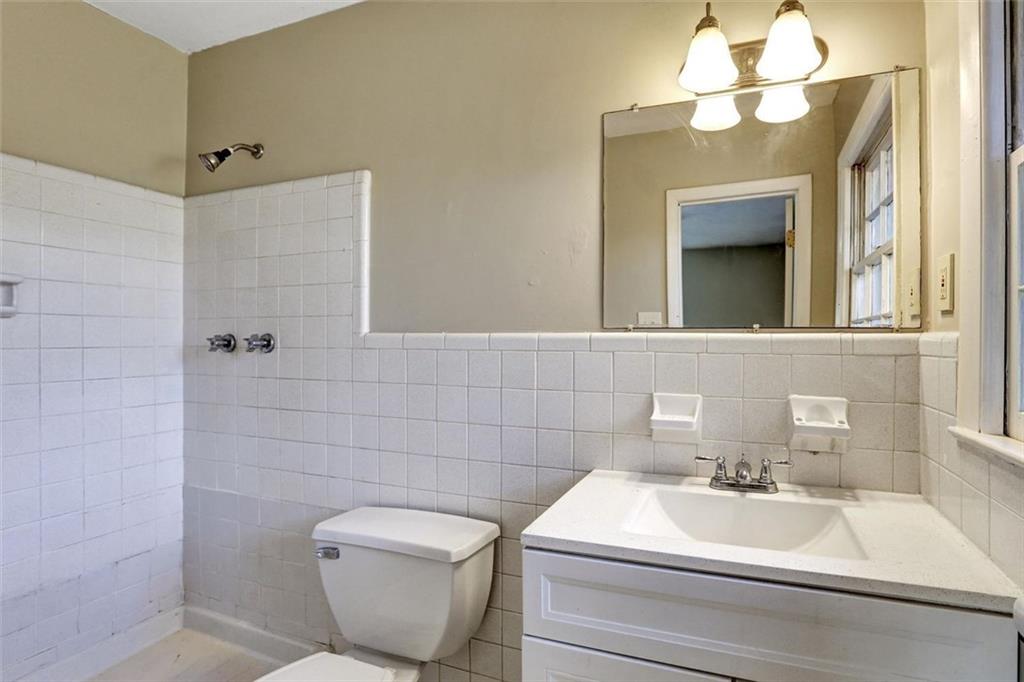 1266 Hickory Drive Southwest Lilburn, GA 30047 - Photo 36 of 49 a bathroom with a toilet sink and mirror