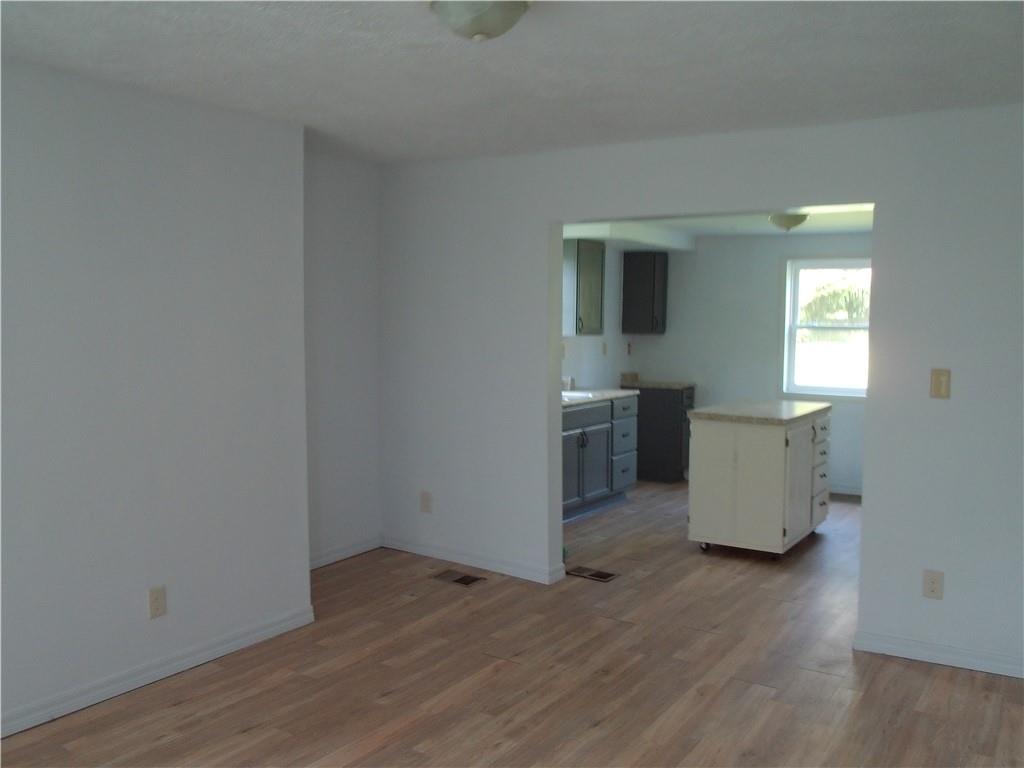 503 Greenfield Road Vanderbilt, PA 15486 - Photo 15 of 36 an empty room with wooden floor and windows