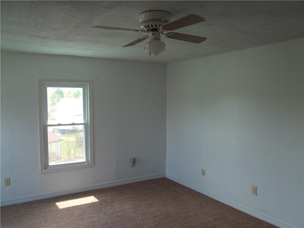 503 Greenfield Road Vanderbilt, PA 15486 - Photo 24 of 36 an empty room with a window and a fan