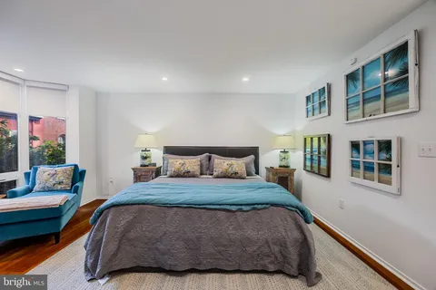 a bedroom with furniture and a large window