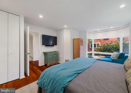 a bedroom with furniture and a window