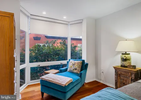 a bedroom with a bed and a television