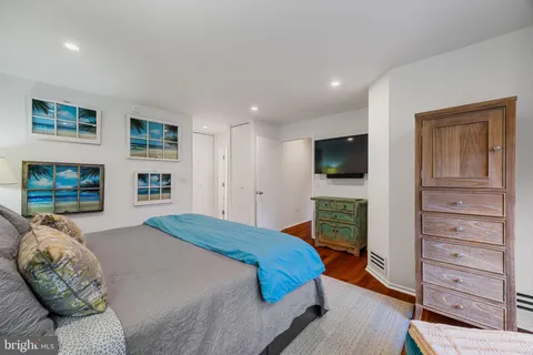 a hallway with white cabinets and entryway