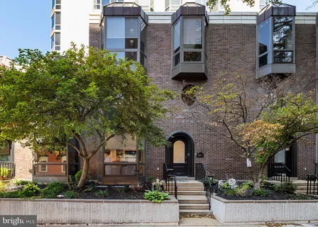 front view of a brick house with a small yard