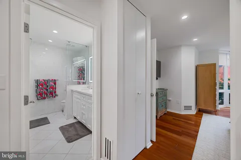 a bathroom with a tub sink and mirror