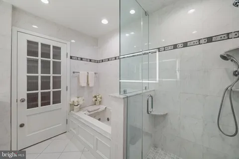 a bathroom with a sink vanity tub and a mirror
