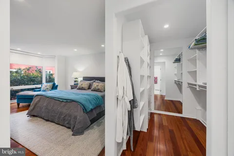 a living room with a couch and a view of kitchen