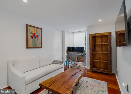 a living room with a flat screen tv and rug