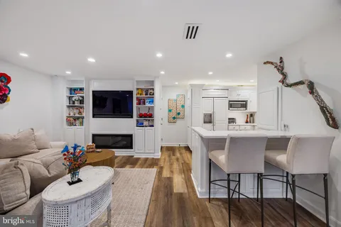 a living room with fireplace furniture and a flat screen tv